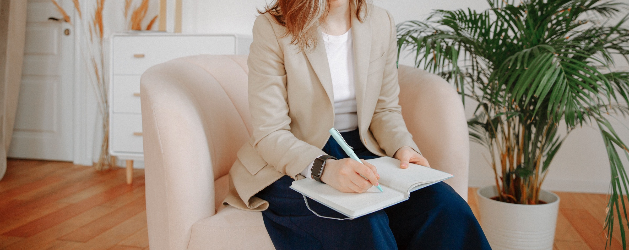 A psychologist taking notes during a supervision session.